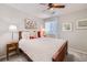 Inviting bedroom with a comfortable bed, ceiling fan, and bright natural light at 1382 Braewood Ave, Highlands Ranch, CO 80129