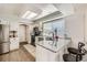 Kitchen with granite counters, white cabinets, and a stainless steel refrigerator at 1382 Braewood Ave, Highlands Ranch, CO 80129