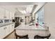 Kitchen with white cabinetry, granite counters, breakfast bar, and stainless steel appliances at 1382 Braewood Ave, Highlands Ranch, CO 80129