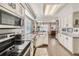 Bright kitchen featuring granite countertops, white cabinets, and stainless steel appliances at 1382 Braewood Ave, Highlands Ranch, CO 80129