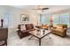 Cozy living room featuring neutral walls, plantation shutters, and comfortable seating at 1382 Braewood Ave, Highlands Ranch, CO 80129