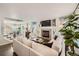 Open-concept living area with a fireplace, sofa, and views of the dining area at 1382 Braewood Ave, Highlands Ranch, CO 80129
