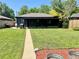 Expansive backyard with green lawn, patio area for relaxation and entertainment, garden plot and mature trees at 1560 Quince St, Denver, CO 80220
