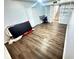 Open basement space with laminate flooring, storage, and a small desk area at 1560 Quince St, Denver, CO 80220