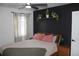 Bedroom with modern decor, stylish curtains, and contemporary black accent wall at 1560 Quince St, Denver, CO 80220