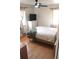 Bedroom with hardwood floors, neutral walls, and stylish curtains providing soft lighting at 1560 Quince St, Denver, CO 80220