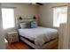 Bright bedroom with hardwood floors, a modern bed, and natural light from two windows at 1560 Quince St, Denver, CO 80220