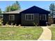 Charming home with manicured front lawn, and modern windows, creating inviting and comfortable curb appeal at 1560 Quince St, Denver, CO 80220