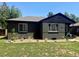 View of this home showcasing a manicured lawn and modern windows, making it an attractive property at 1560 Quince St, Denver, CO 80220