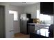 Bright kitchen features stainless steel refrigerator, sleek black dishwasher, and modern faucet at 1560 Quince St, Denver, CO 80220