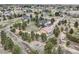 Aerial view of property featuring home, outbuilding, and expansive land with scattered trees and neighborhood homes at 3562 Pine Meadow Ave, Parker, CO 80138
