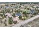 Aerial view of a home with outbuilding, solar panels, and sprawling grounds in a serene community at 3562 Pine Meadow Ave, Parker, CO 80138