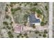 Overhead aerial view exhibits home, barn, driveway, and generous lot outlined by trees at 3562 Pine Meadow Ave, Parker, CO 80138