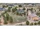 Beautiful aerial view of a landscaped property, with outbuilding and fenced yard surrounded by mature trees at 3562 Pine Meadow Ave, Parker, CO 80138