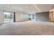 Spacious finished basement featuring large windows, neutral carpeting, and a sliding glass door to the outside at 3562 Pine Meadow Ave, Parker, CO 80138