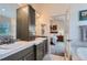 This bathroom features a double sink vanity and a glass door to the bedroom at 3562 Pine Meadow Ave, Parker, CO 80138