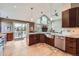 Modern kitchen featuring stainless steel appliances, dark wood cabinetry, and breakfast bar at 3562 Pine Meadow Ave, Parker, CO 80138