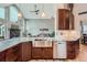 Spacious kitchen featuring granite countertops, stainless steel sink, and open view to the living area at 3562 Pine Meadow Ave, Parker, CO 80138