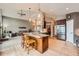Open concept kitchen with large island, stainless steel appliances, and connected living space at 3562 Pine Meadow Ave, Parker, CO 80138