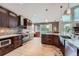 Bright kitchen with stainless steel appliances, island bar, sleek cabinetry, and light wood floors at 3562 Pine Meadow Ave, Parker, CO 80138