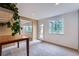 Bright living room with plush carpeting, a large window, and an adjacent dining area with views to the outside at 3562 Pine Meadow Ave, Parker, CO 80138