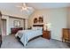 This is a bright main bedroom with a window and an eye-catching piece of wall art and comfortable furnishings at 3562 Pine Meadow Ave, Parker, CO 80138