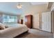 This is a bright main bedroom with vaulted ceiling, ceiling fan, and an abundance of closet and dresser storage at 3562 Pine Meadow Ave, Parker, CO 80138