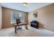 Home office space with desk, chair, shelving and bright window overlooking trees at 3562 Pine Meadow Ave, Parker, CO 80138