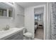 Basement bathroom with a vanity, toilet, and view into bedroom at 3742 S Danube Cir, Aurora, CO 80013