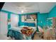 Basement bedroom with a double bed and teal walls at 3742 S Danube Cir, Aurora, CO 80013