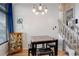 Bright dining area with table and chairs, light wood floors, and a view of a staircase at 3742 S Danube Cir, Aurora, CO 80013