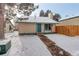 Cute house exterior with snowy yard, walkway, and wood fence at 3742 S Danube Cir, Aurora, CO 80013