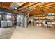 Unfinished basement with laundry and storage at 10886 E Berry Ave, Englewood, CO 80111