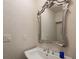 Elegant half bathroom with stylish fixtures and a decorative mirror at 10886 E Berry Ave, Englewood, CO 80111