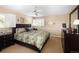 Inviting bedroom with a ceiling fan, large windows, and classic furnishings for a relaxing space at 10886 E Berry Ave, Englewood, CO 80111