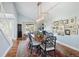 Bright dining room with a long wooden table, seating for six, and decorative artwork on the walls at 10886 E Berry Ave, Englewood, CO 80111