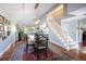 Elegant dining room with hardwood floors, a large rug, and a modern chandelier above a wooden dining table at 10886 E Berry Ave, Englewood, CO 80111