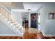 Inviting foyer with hardwood floors and a staircase, perfect for welcoming guests at 10886 E Berry Ave, Englewood, CO 80111
