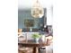 Bright kitchen with center island and an ornate chandelier with access to the dining and living area at 10886 E Berry Ave, Englewood, CO 80111