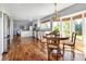 Sunlit kitchen and dining area with hardwood floors, white cabinets and modern appliances at 10886 E Berry Ave, Englewood, CO 80111