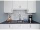 Stylish kitchenette featuring modern cabinetry, sleek countertops, and stainless steel appliances at 10886 E Berry Ave, Englewood, CO 80111