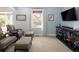 Cozy living room featuring plush seating, neutral colors, and a modern entertainment center at 10886 E Berry Ave, Englewood, CO 80111