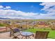 Landscaped backyard featuring a stone patio with a fire pit and mountain views at 13325 W 86Th Dr, Arvada, CO 80005