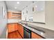 Elegant bar area featuring a dark countertop, wine rack, modern lighting, and a sink at 13325 W 86Th Dr, Arvada, CO 80005