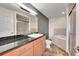 Modern bathroom featuring a sleek vanity, large mirror, walk-in shower, and soaking tub at 13325 W 86Th Dr, Arvada, CO 80005