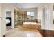 Large bathroom with dual shower heads, jacuzzi style tub, and a tiled floor and surrounding walls at 13325 W 86Th Dr, Arvada, CO 80005