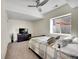 Cozy bedroom with a plaid comforter, a TV on a dark dresser, and natural light at 13325 W 86Th Dr, Arvada, CO 80005