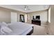 Neutral bedroom with a ceiling fan, and carpet flooring, with an adjoining bathroom for convenience at 13325 W 86Th Dr, Arvada, CO 80005