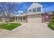 Beautiful two-story home with a wide driveway and a welcoming front yard at 13325 W 86Th Dr, Arvada, CO 80005