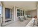 Inviting front porch with comfortable seating and a stylish entryway at 13325 W 86Th Dr, Arvada, CO 80005